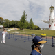 Former Japanese swimmer Aya Terakawa carries the Tokyo 2020 Olympic torch during the torch relay at the Expo ‘70 Commemorative Park in Suita, after it was barred from public roads across Osaka region due to a spike in coronavirus (COVID-19) cases.